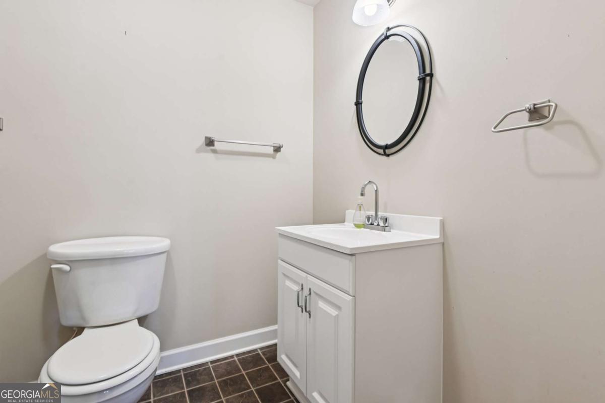 3180 The Commons Drive Cumming, GA 30041 - Photo 67 of 84 a bathroom with a toilet a sink and a mirror
