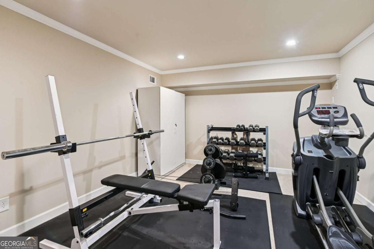 3180 The Commons Drive Cumming, GA 30041 - Photo 69 of 84 a room with gym equipment and a wooden floor