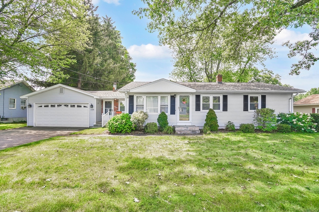 a front view of a house with a garden and porch