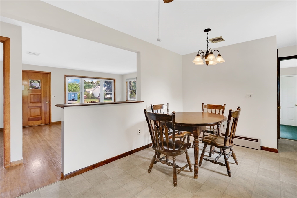1133 Burnett Road Chicopee, MA 01020 - Photo 12 of 40 a view of a dining room with furniture and wooden floor