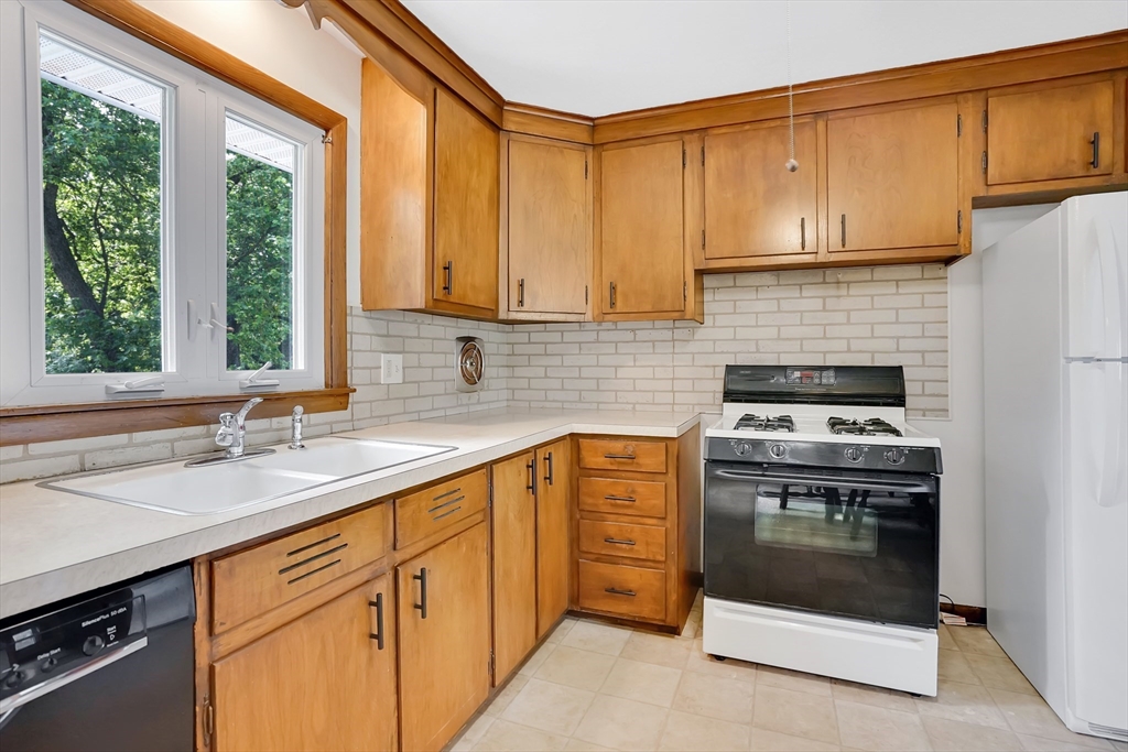 1133 Burnett Road Chicopee, MA 01020 - Photo 13 of 40 a kitchen with stainless steel appliances granite countertop a sink stove and cabinets