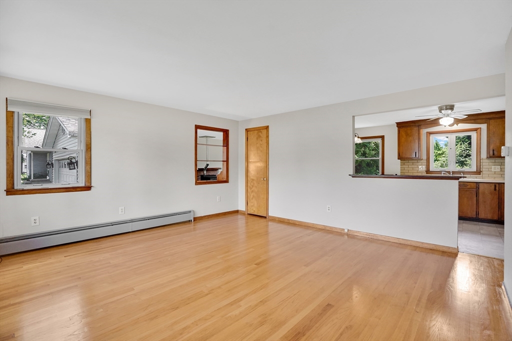 1133 Burnett Road Chicopee, MA 01020 - Photo 17 of 40 a view of an empty room with wooden floor and a window
