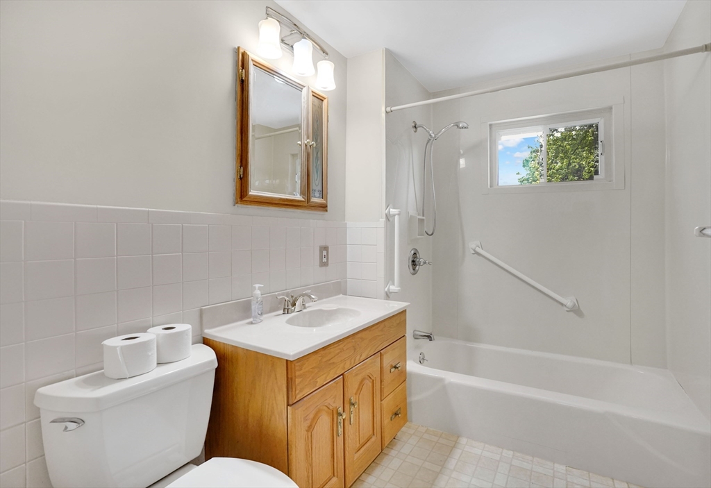 1133 Burnett Road Chicopee, MA 01020 - Photo 20 of 40 a bathroom with a tub sink and mirror on the wall