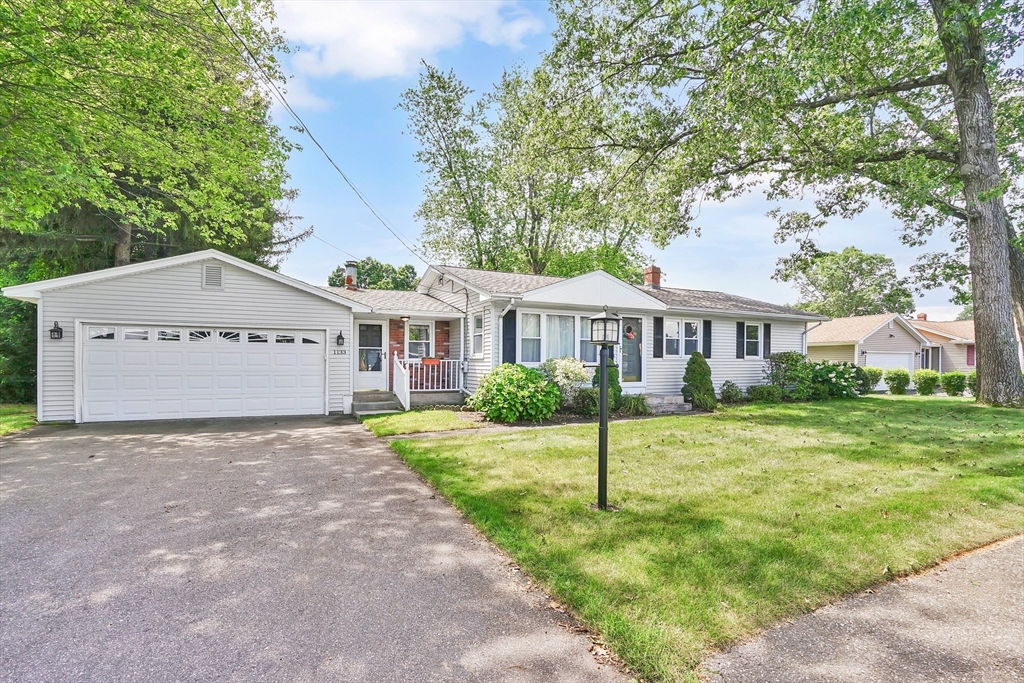 1133 Burnett Road Chicopee, MA 01020 - Photo 2 of 40 a view of a house with yard and a garden