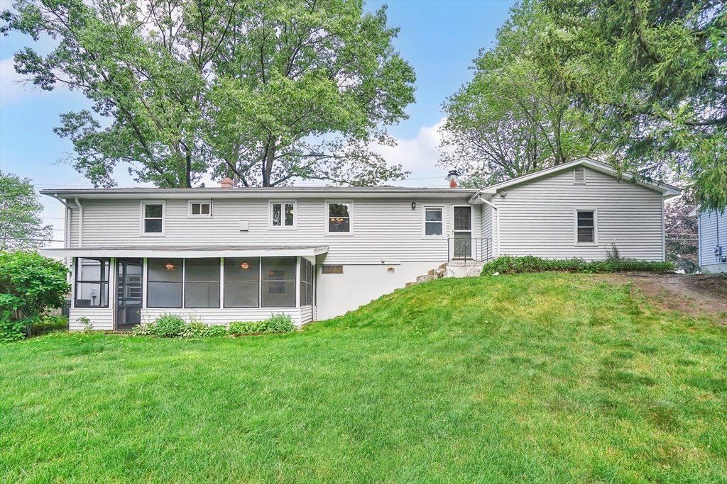 1133 Burnett Road Chicopee, MA 01020 - Photo 3 of 40 a front view of house with yard and green space