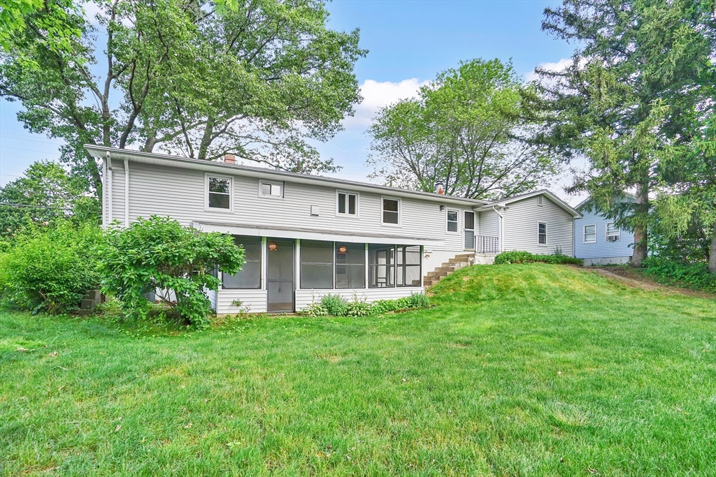 1133 Burnett Road Chicopee, MA 01020 - Photo 4 of 40 a view of a house with a yard and potted plants