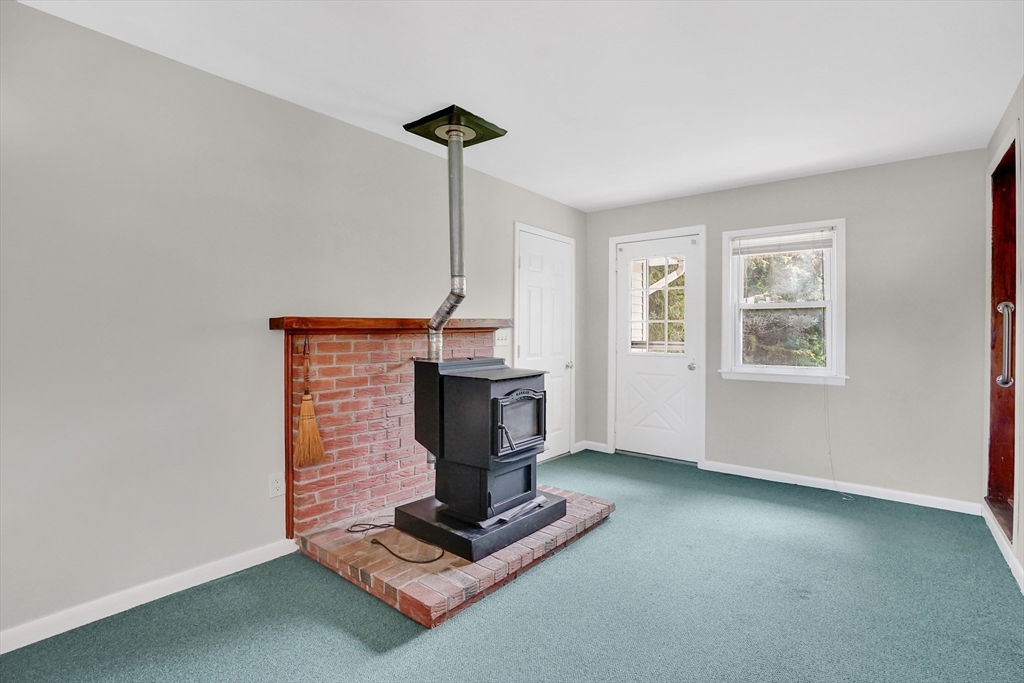 1133 Burnett Road Chicopee, MA 01020 - Photo 6 of 40 a living room with furniture and a fireplace