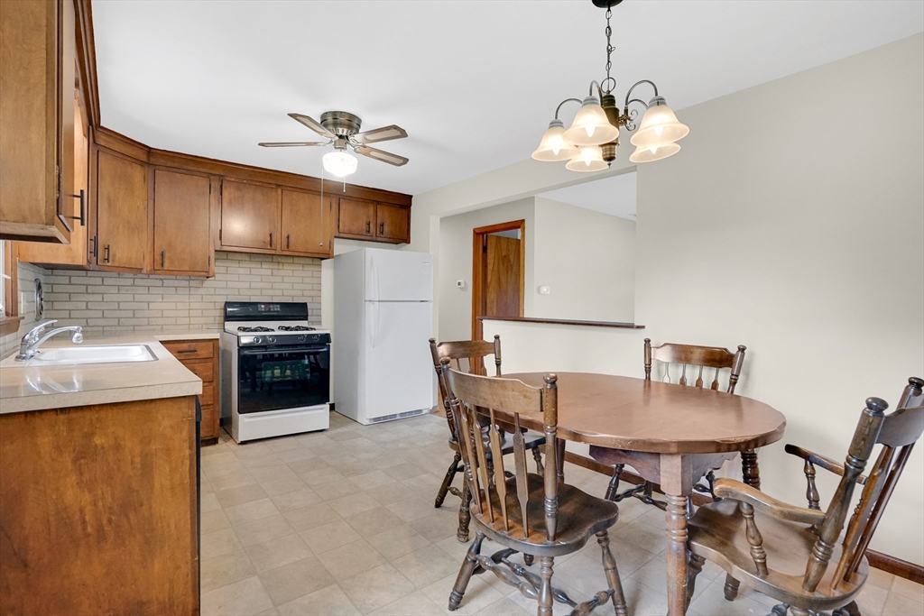 1133 Burnett Road Chicopee, MA 01020 - Photo 8 of 40 a kitchen with a dining table and chairs