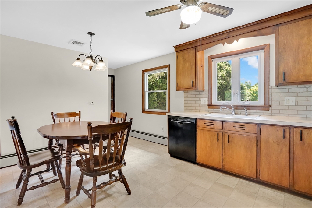 1133 Burnett Road Chicopee, MA 01020 - Photo 10 of 40 a view of a dining room with furniture a chandelier and window