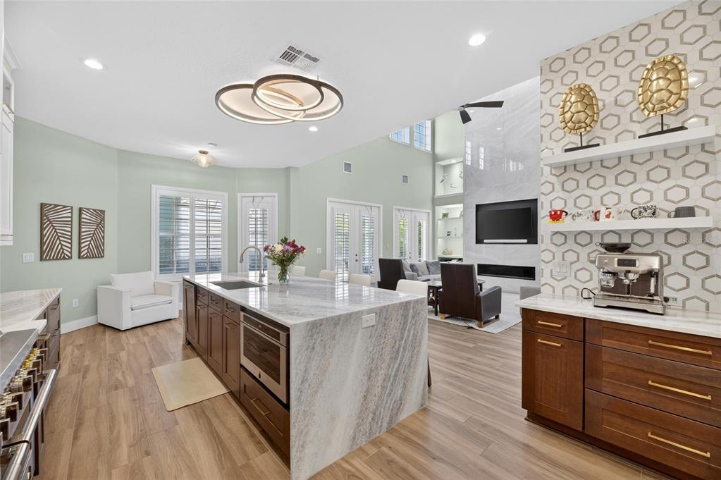 508 Islebay Drive Apollo Beach, FL 33572 - Photo 32 of 98 a large kitchen with stainless steel appliances granite countertop a stove and a wooden floor