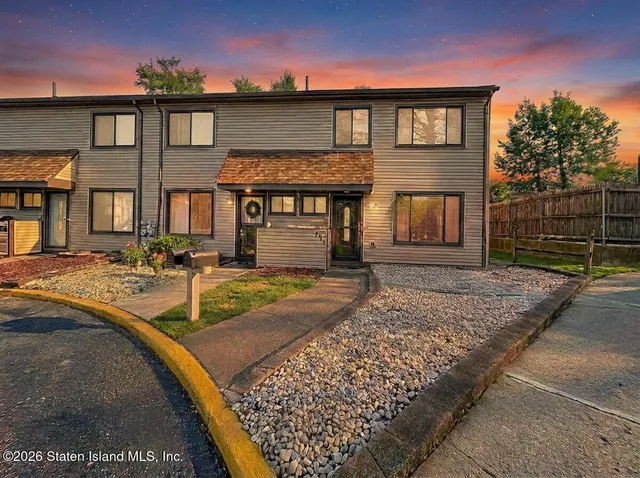 a living room with furniture a fireplace and a table