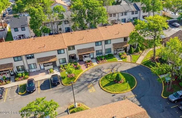 an aerial view of a house with garden space and street view