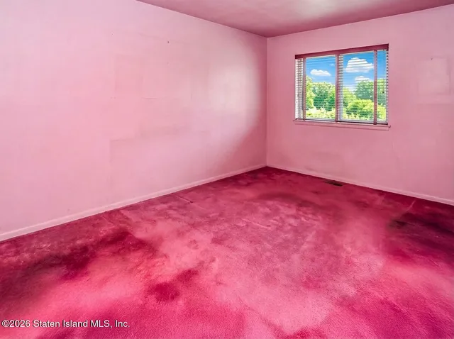 a view of a room with a window and a ceiling fan