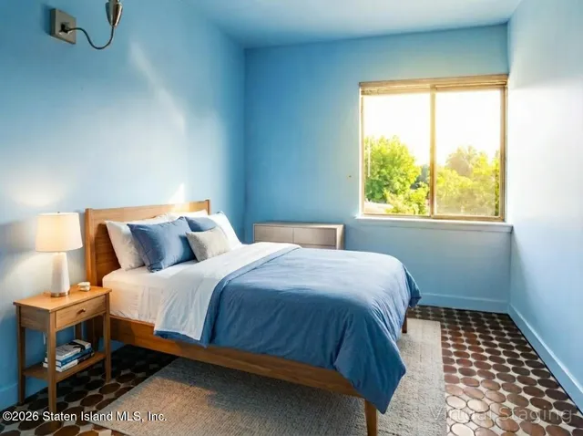 a bedroom with a bed and a window