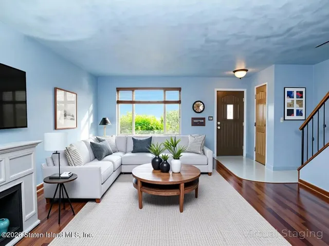 a living room with furniture and a wooden floor