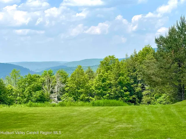 a kitchen with a sink a counter top space and a large window