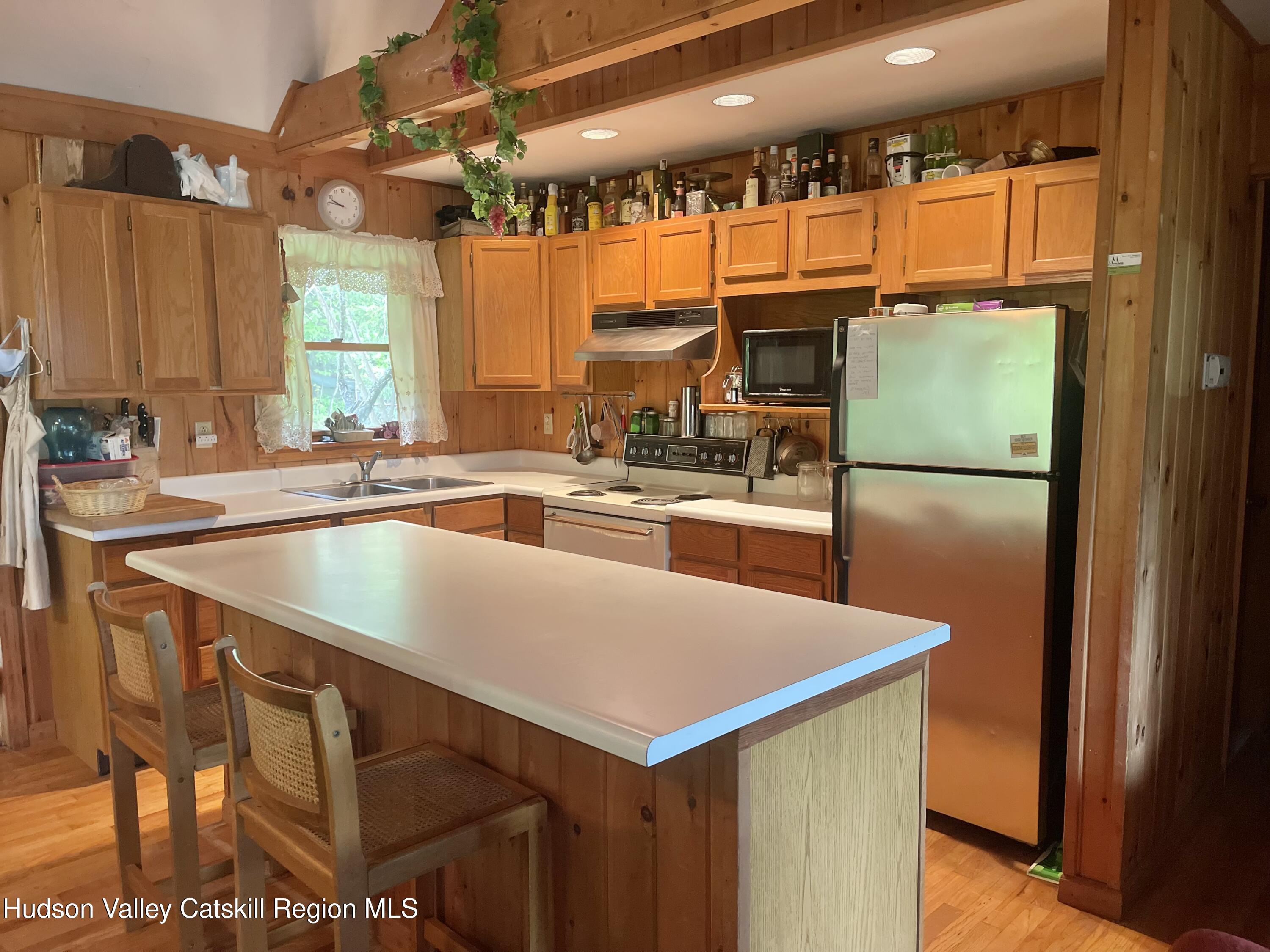 27 Terrace Drive Lexington, NY 12468 - Photo 18 of 37 a kitchen with a sink a counter top space and a large window