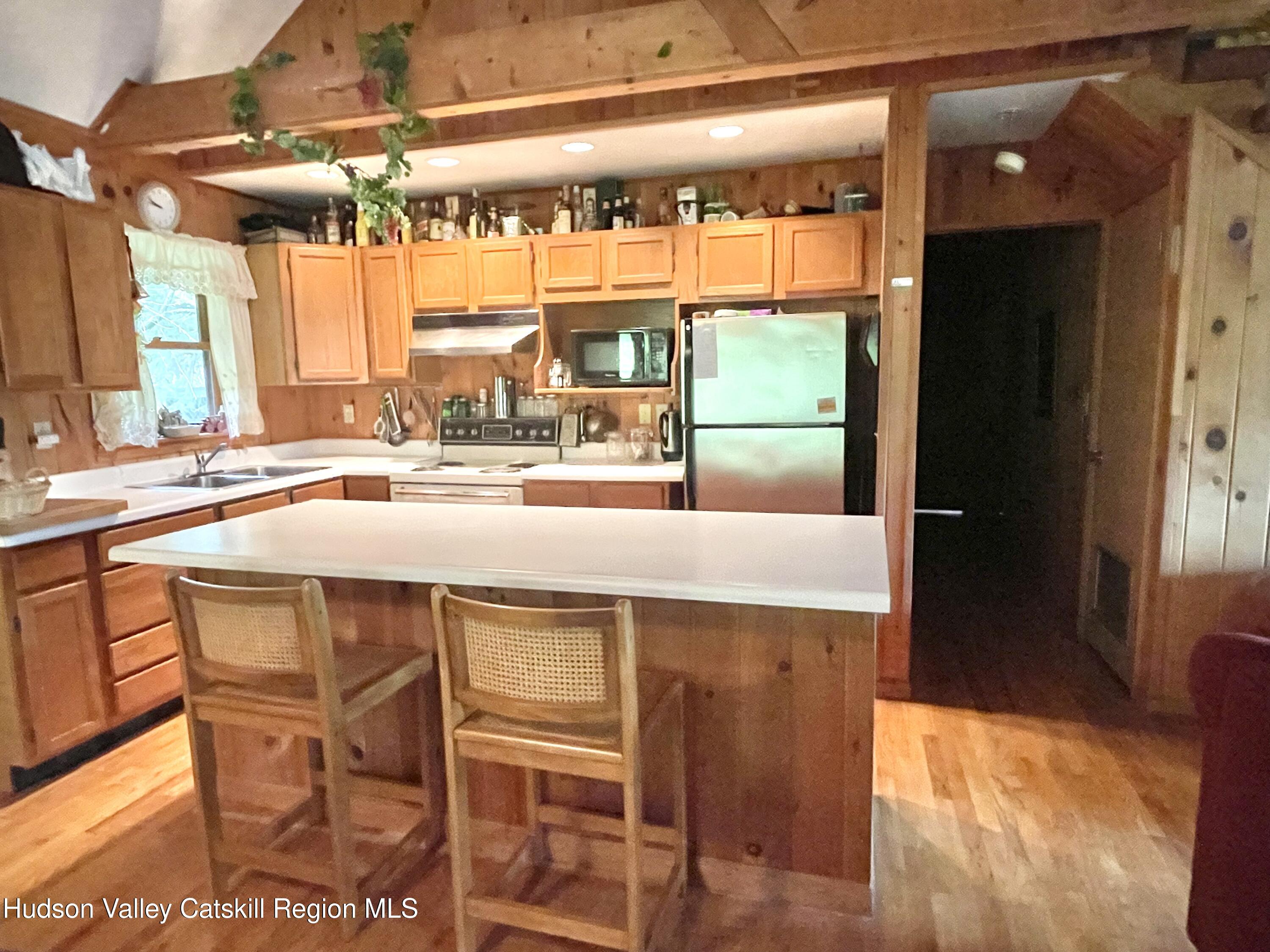 27 Terrace Drive Lexington, NY 12468 - Photo 19 of 37 a kitchen with a table chairs and a wooden floor
