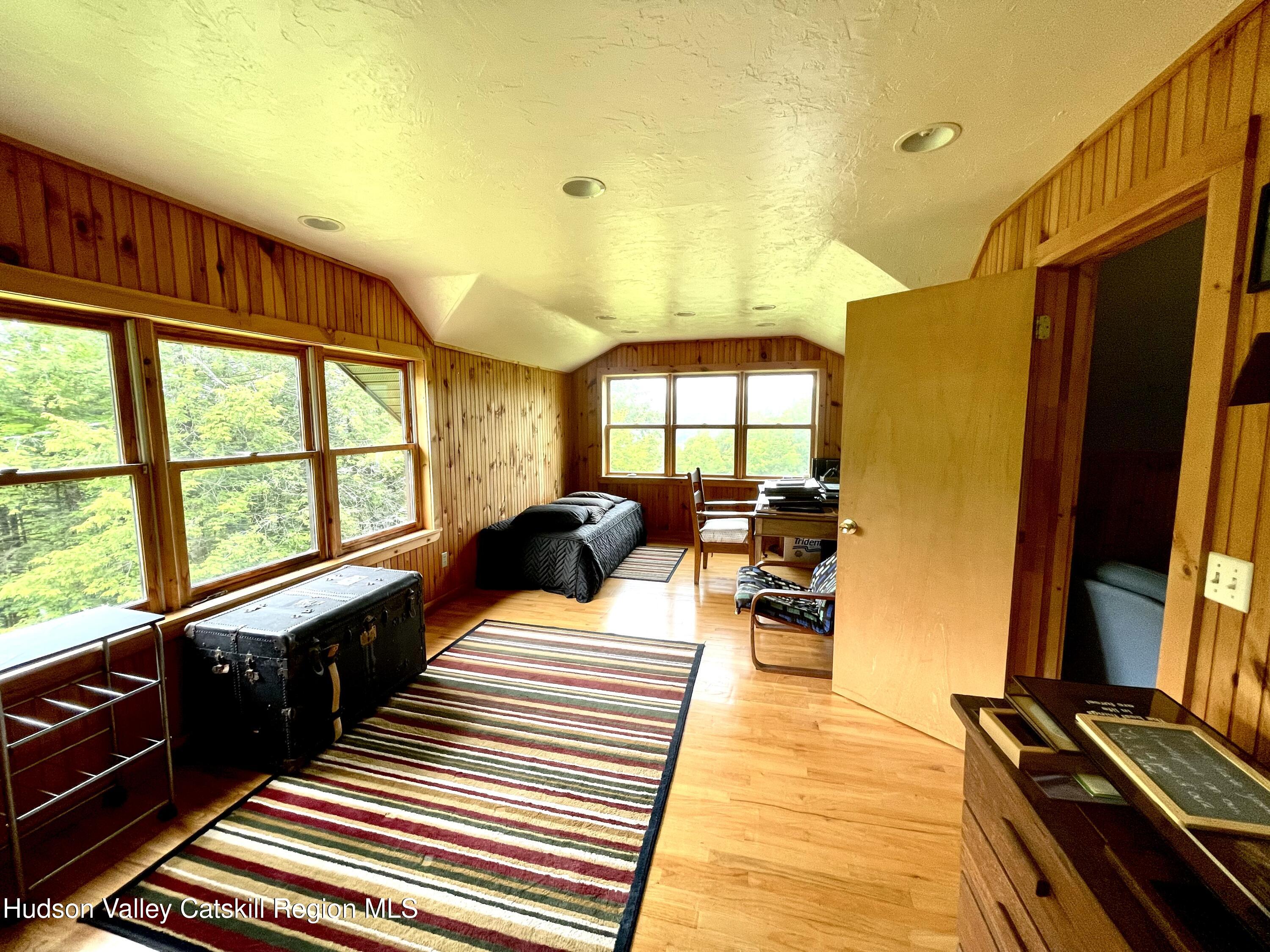 27 Terrace Drive Lexington, NY 12468 - Photo 34 of 37 a large bedroom with a bed and wooden floor