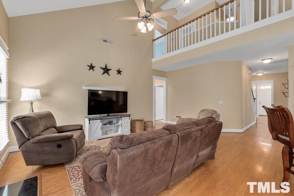 216 Frontgate Drive Cary, NC 27519 - Photo 11 of 26 a living room with furniture and a flat screen tv
