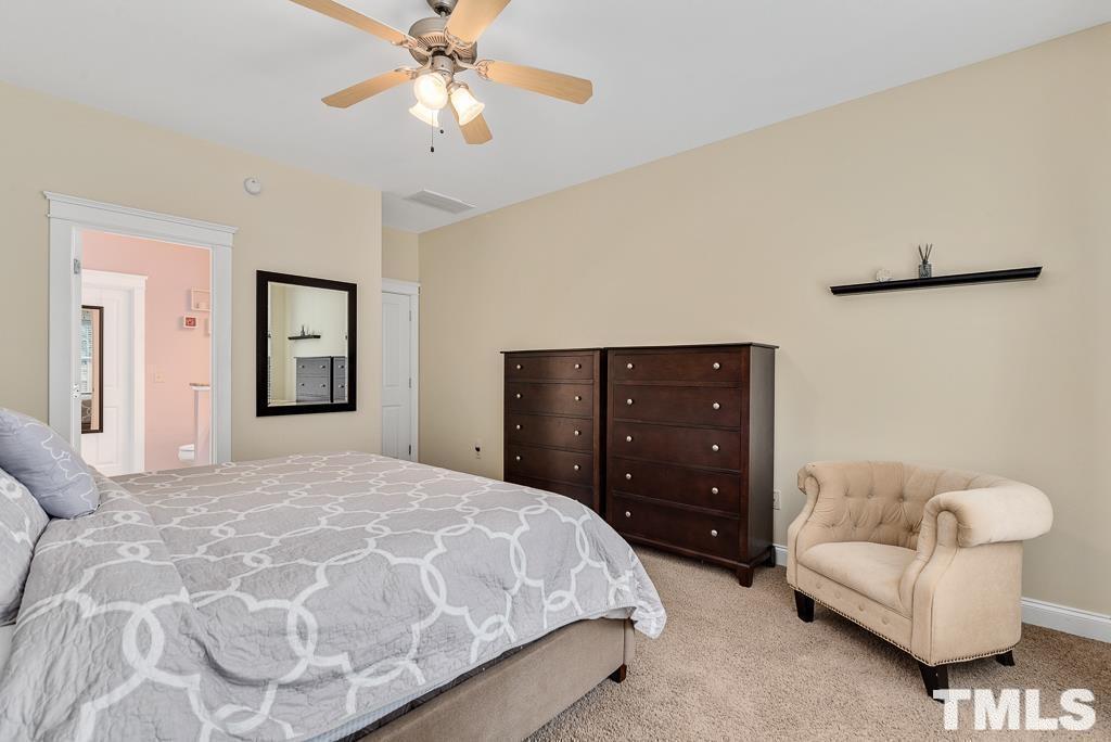 216 Frontgate Drive Cary, NC 27519 - Photo 16 of 26 a bedroom with a bed and a couch