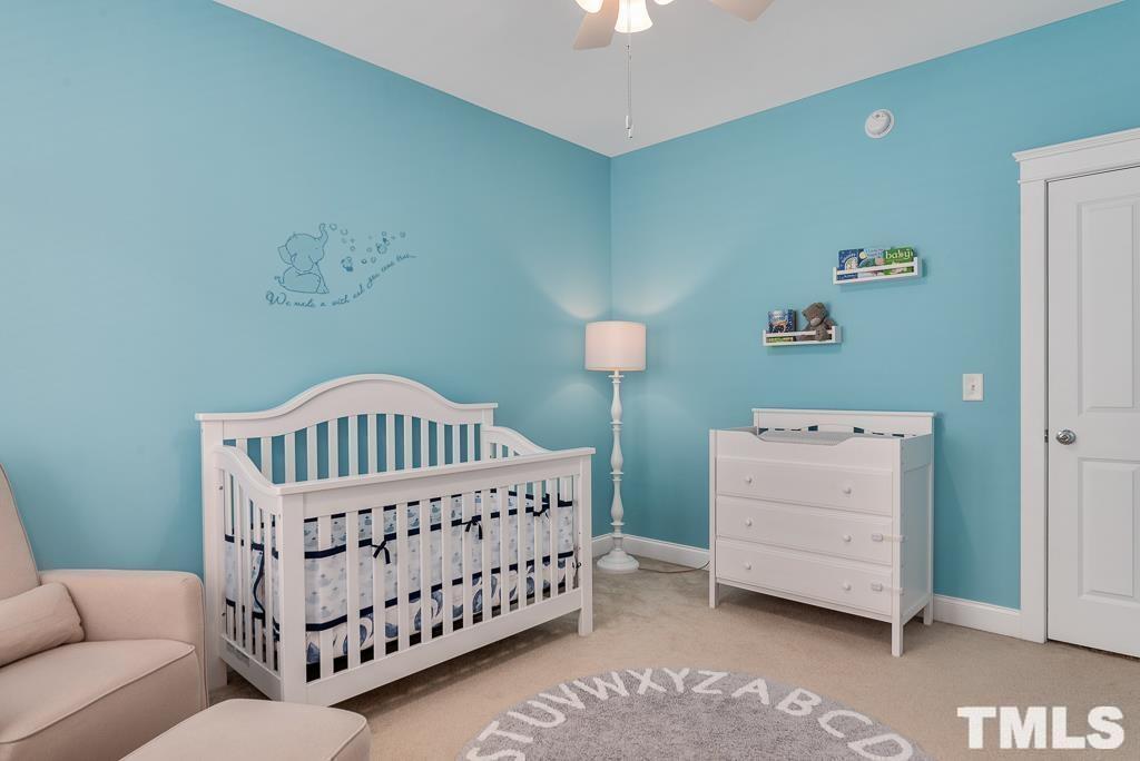 216 Frontgate Drive Cary, NC 27519 - Photo 21 of 26 a bedroom with a baby bed and a dresser