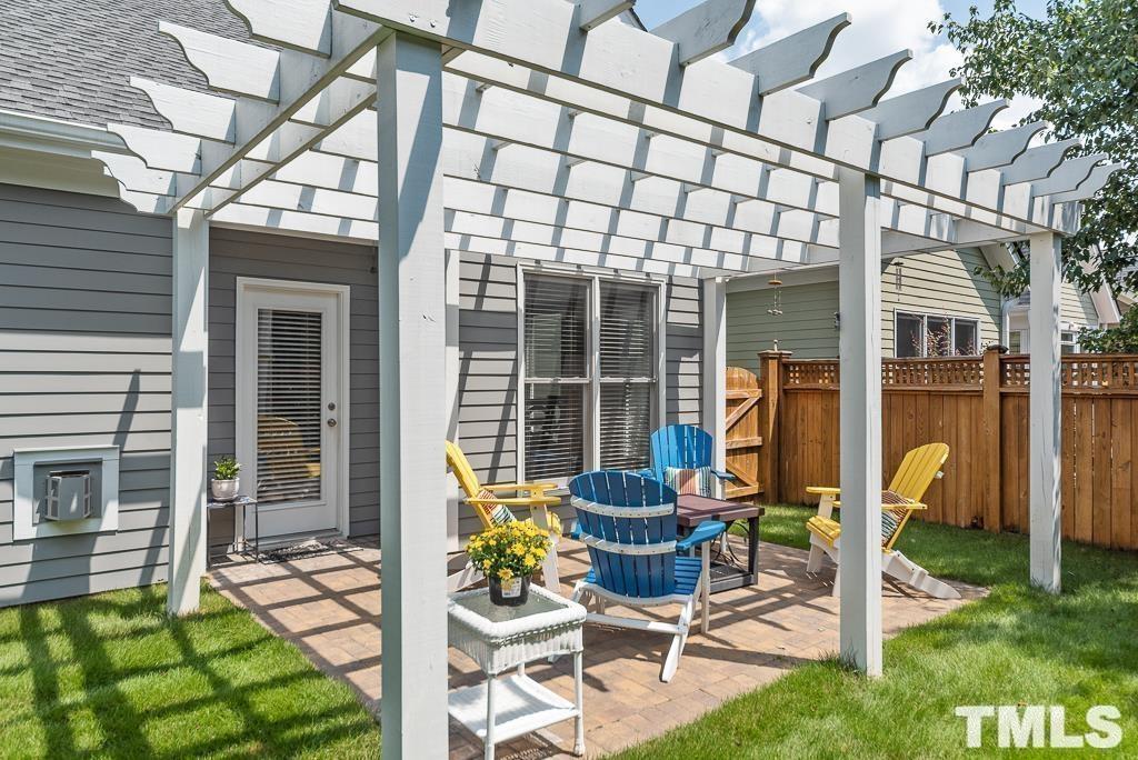 216 Frontgate Drive Cary, NC 27519 - Photo 22 of 26 a view of a chair and tables in the back yard of the house