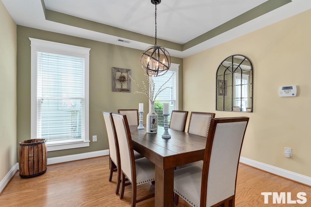 216 Frontgate Drive Cary, NC 27519 - Photo 4 of 26 a view of a dining room with furniture window and wooden floor