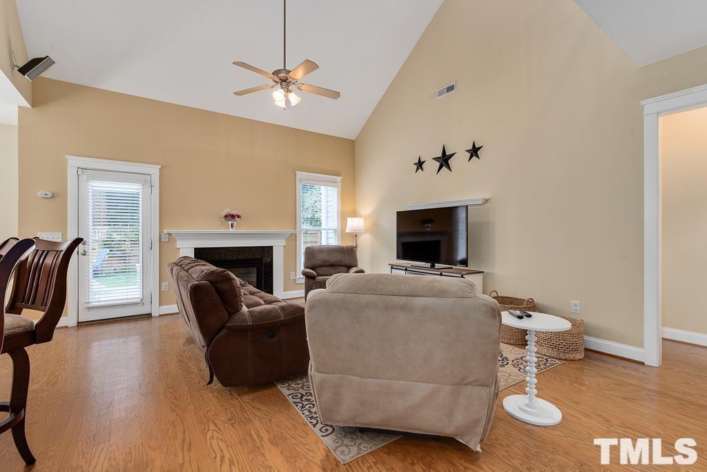 216 Frontgate Drive Cary, NC 27519 - Photo 9 of 26 a living room with furniture a fireplace and a flat screen tv