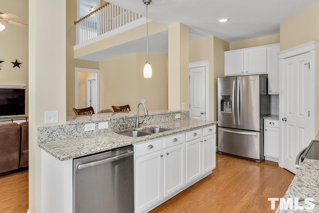 216 Frontgate Drive Cary, NC 27519 - Photo 10 of 26 a kitchen with stainless steel appliances granite countertop a sink stove and refrigerator