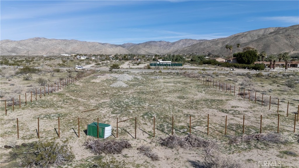 65 Dillon Road Desert Hot Springs, CA 92241 - Photo 11 of 24 a view of a dry yard with mountains in the background