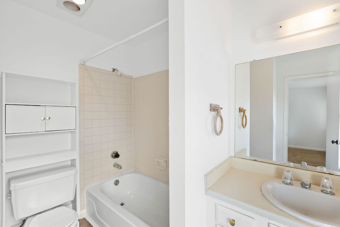 1712 Timber Ridge Road Austin, TX 78741 - Photo 23 of 35 a bathroom with a bathtub and a sink