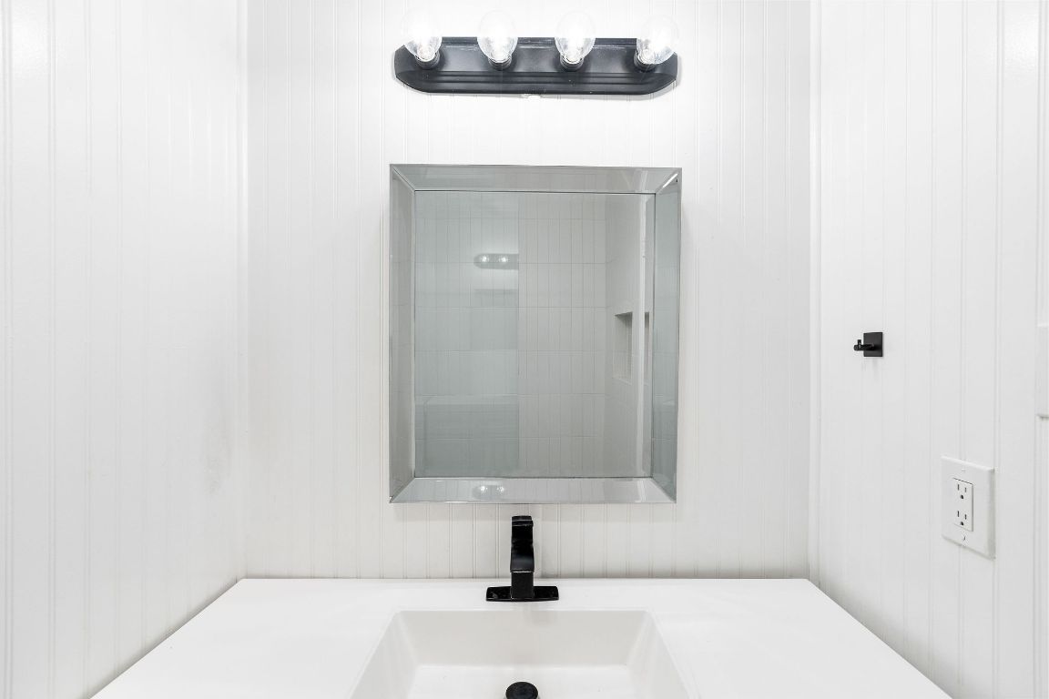 1712 Timber Ridge Road Austin, TX 78741 - Photo 29 of 35 a bathroom with a sink and a mirror