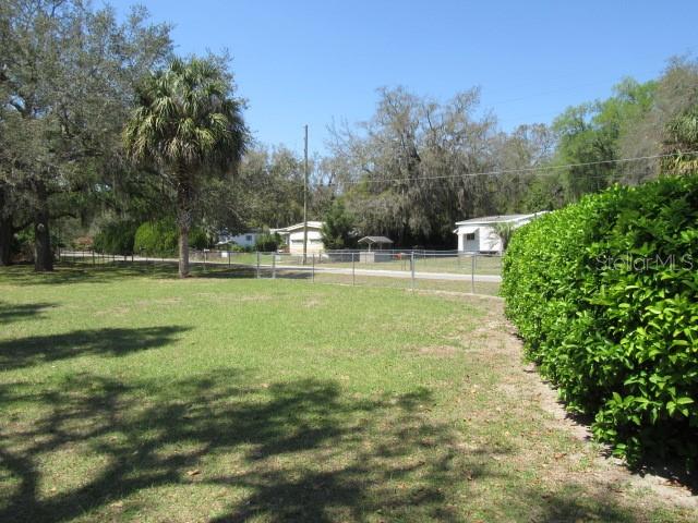 Southeast 102nd Court Road Summerfield, FL 34491 - Photo 2 of 10 a view of a swimming pool with a big yard and large trees