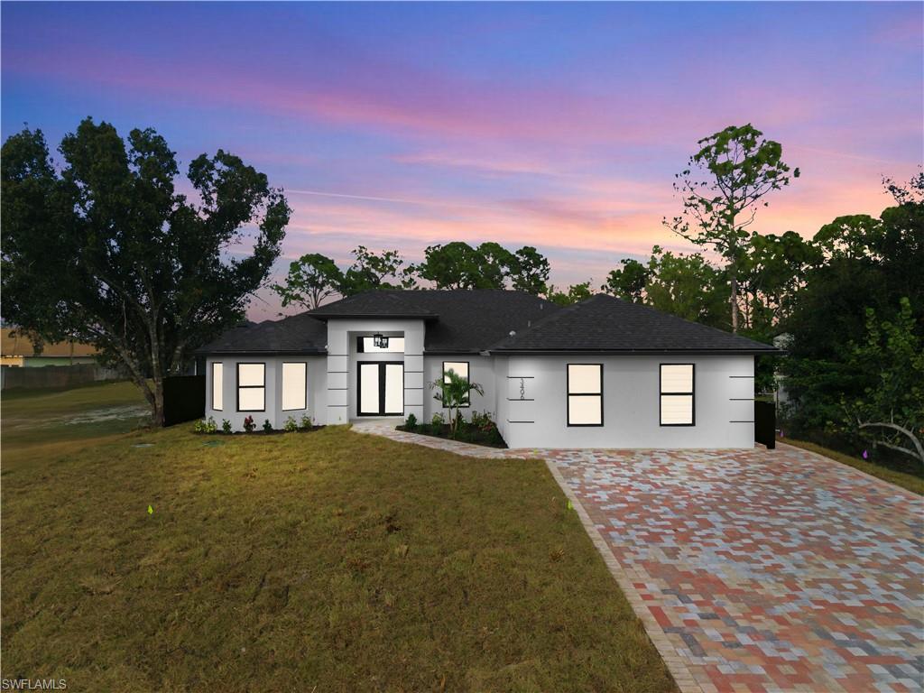a front view of a house with a yard and garage