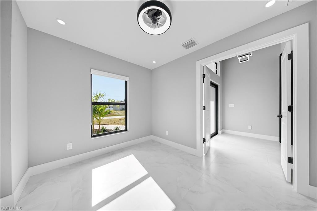 3406 25th Street Southwest Lehigh Acres, FL 33976 - Photo 13 of 44 a view of empty room with window and ceiling fan