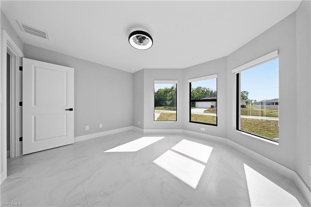 3406 25th Street Southwest Lehigh Acres, FL 33976 - Photo 15 of 44 a view of an empty room with a window