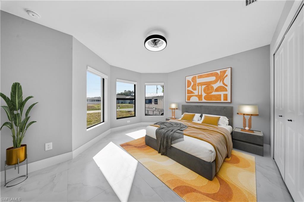 3406 25th Street Southwest Lehigh Acres, FL 33976 - Photo 16 of 44 a bedroom with a bed and a potted plant