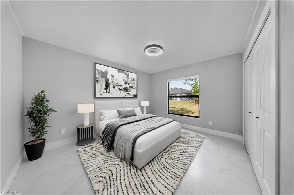 3406 25th Street Southwest Lehigh Acres, FL 33976 - Photo 18 of 44 a bedroom with a large bed and a potted plant