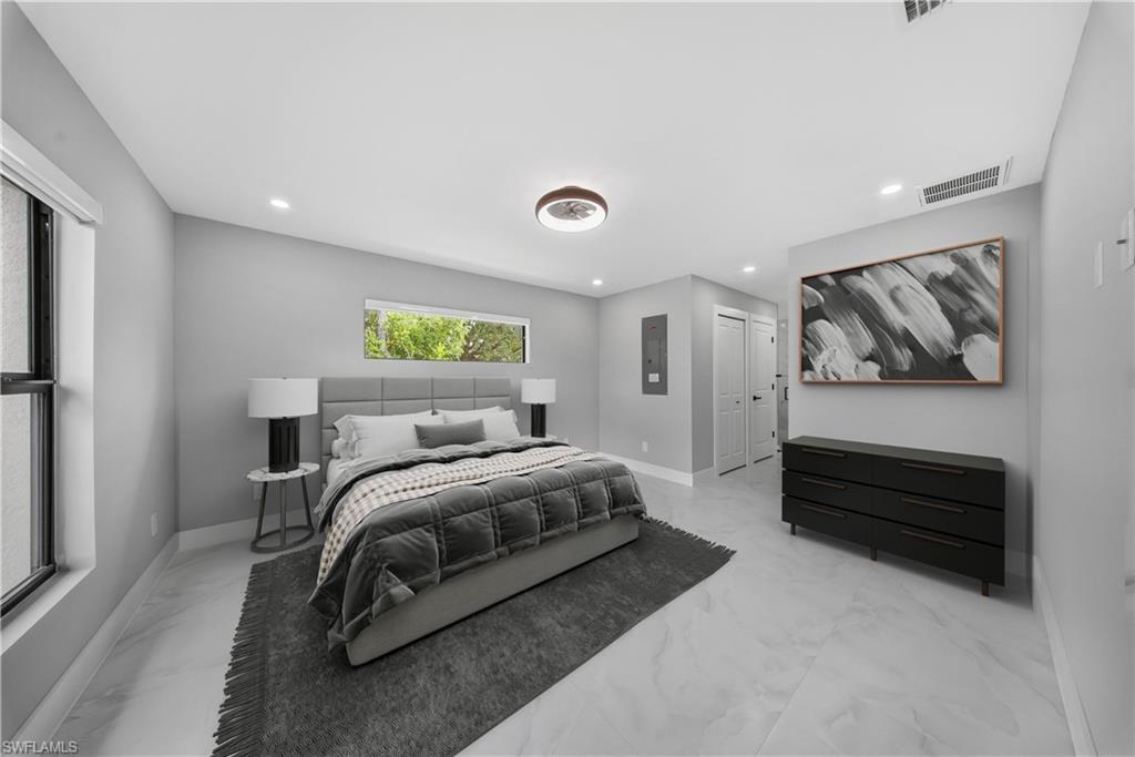 3406 25th Street Southwest Lehigh Acres, FL 33976 - Photo 22 of 44 a bedroom with a bed and a cabinets