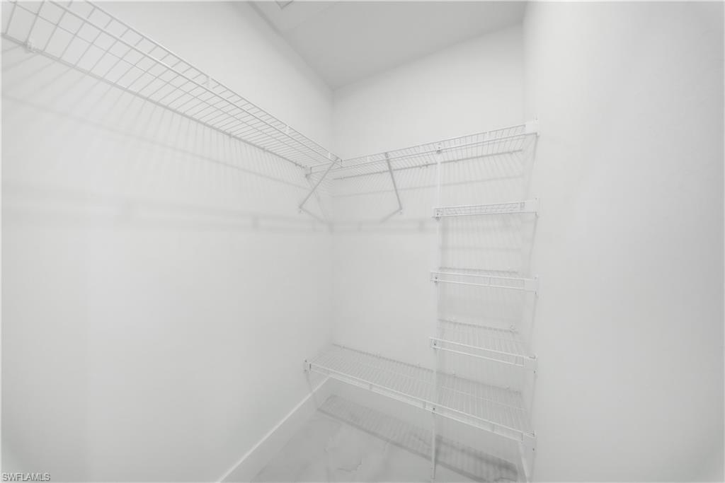 3406 25th Street Southwest Lehigh Acres, FL 33976 - Photo 23 of 44 MASTER BEDROOM-Walk in closet #1 -with marble look tile flooring