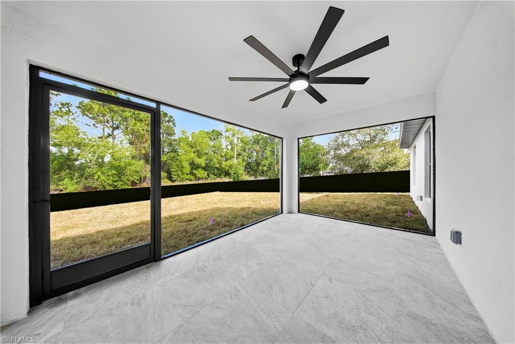 3406 25th Street Southwest Lehigh Acres, FL 33976 - Photo 26 of 44 a view of an empty room with a window and a ceiling fan
