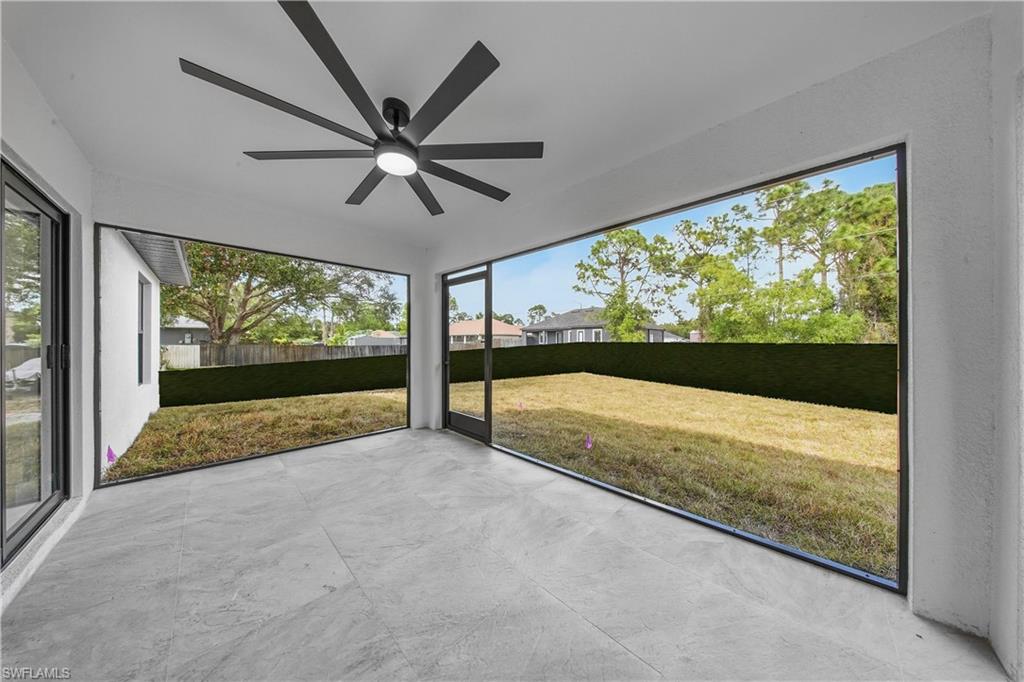 3406 25th Street Southwest Lehigh Acres, FL 33976 - Photo 27 of 44 a view of an empty room with a fireplace and a ceiling fan