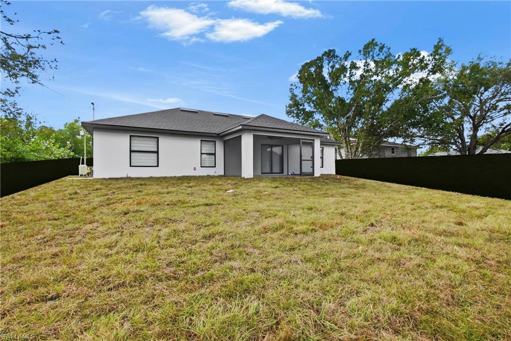 3406 25th Street Southwest Lehigh Acres, FL 33976 - Photo 30 of 44 a view of a house with a yard