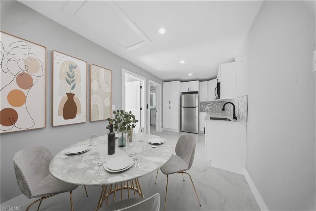 3406 25th Street Southwest Lehigh Acres, FL 33976 - Photo 35 of 44 a dining room with furniture and wooden floor