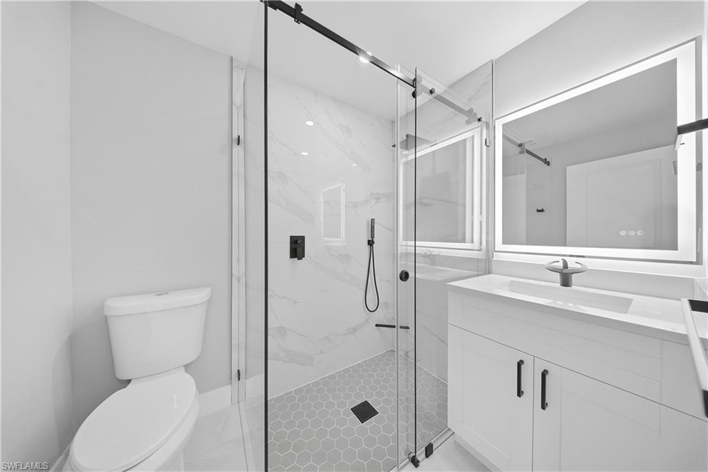 3406 25th Street Southwest Lehigh Acres, FL 33976 - Photo 41 of 44 a bathroom with a toilet shower vanity and a sink