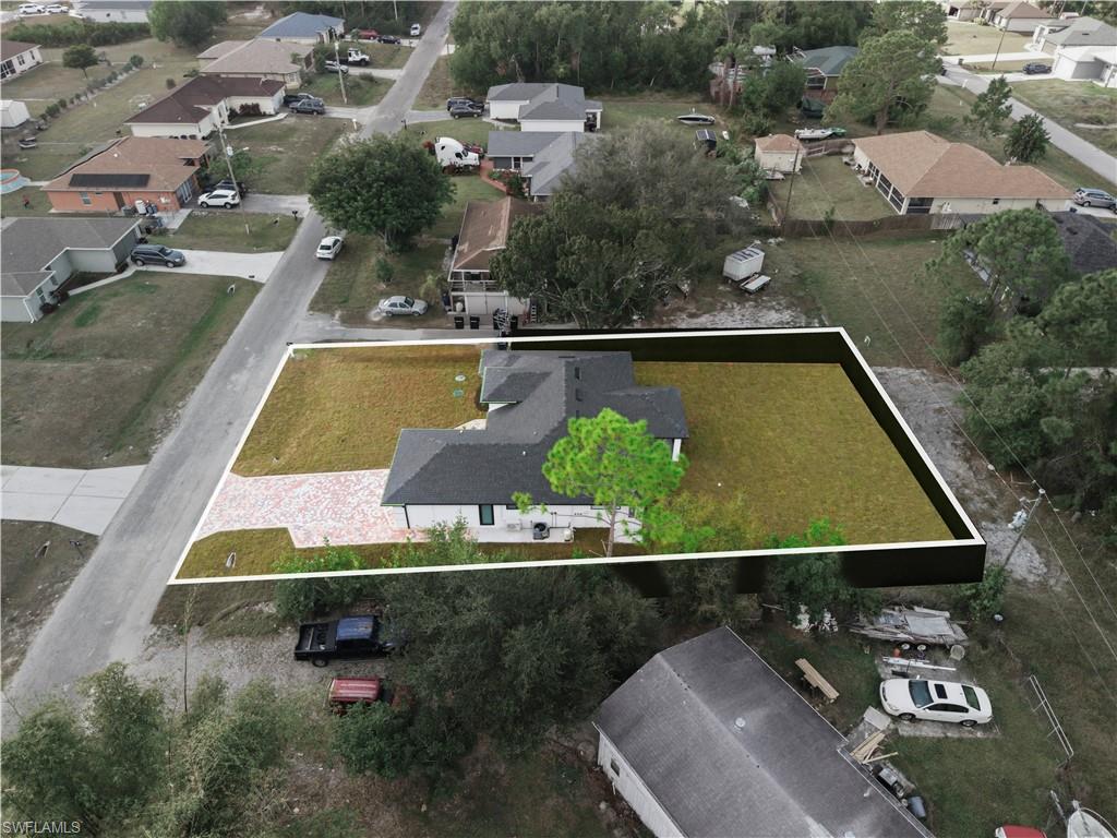 3406 25th Street Southwest Lehigh Acres, FL 33976 - Photo 43 of 44 an aerial view of a house with a swimming pool