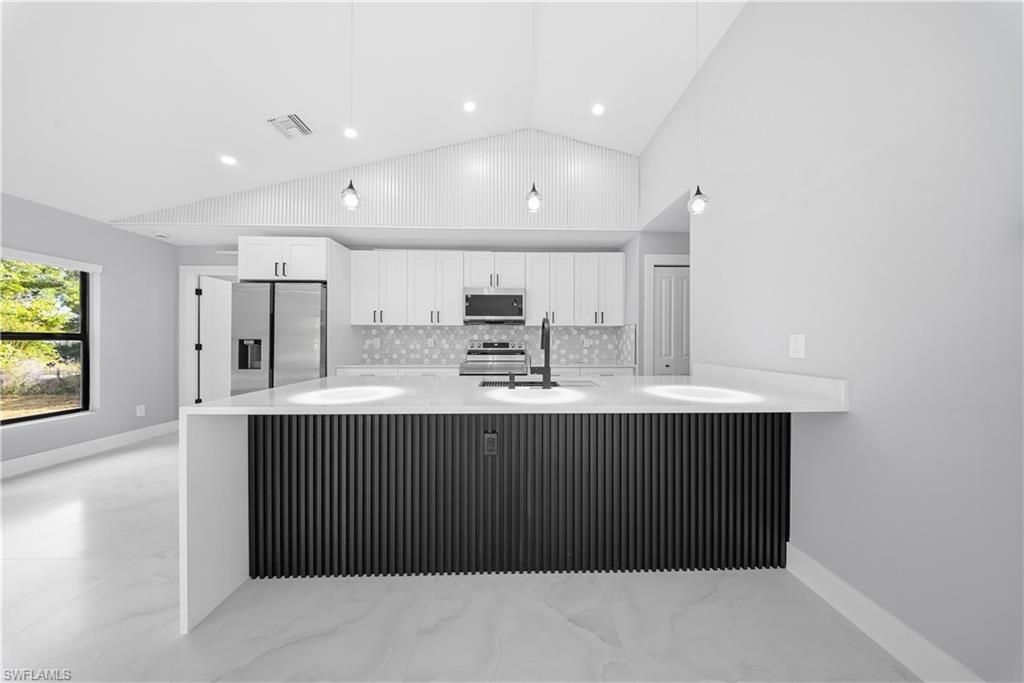 3406 25th Street Southwest Lehigh Acres, FL 33976 - Photo 7 of 44 a view of kitchen with stainless steel appliances cabinets