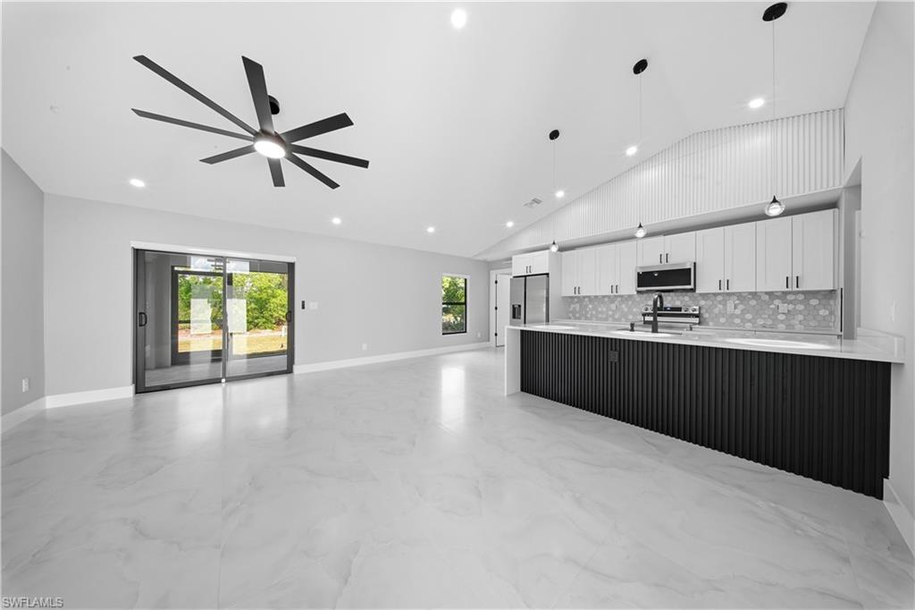 3406 25th Street Southwest Lehigh Acres, FL 33976 - Photo 44 of 44 a view of a kitchen with a sink and dishwasher a refrigerator with wooden floor