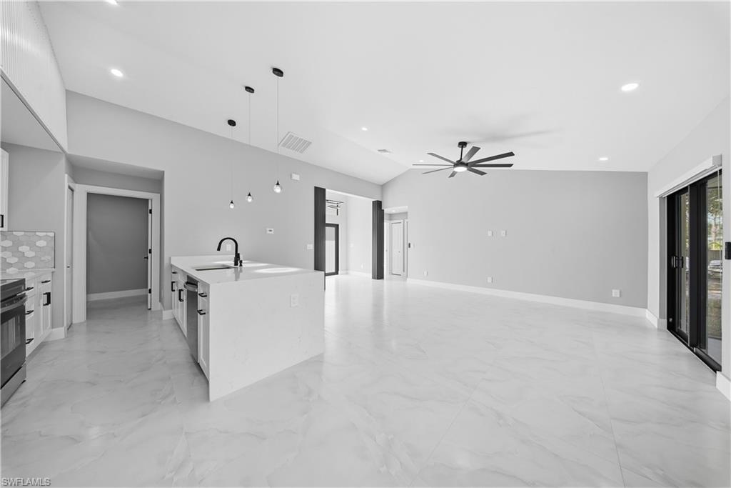 3406 25th Street Southwest Lehigh Acres, FL 33976 - Photo 8 of 44 a view of a livingroom with furniture and a ceiling fan